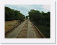 03-027 * A very long wooden bridge raises the road above most seasonal flooding * A very long wooden bridge raises the road above most seasonal flooding