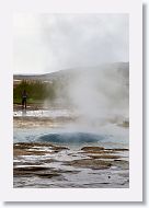 As it erupts, the water forms a blue bubble before the steam breaks the surface tension