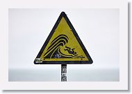 Sign warning of sneaker waves that can suddenly crash on the beach and wash tourists out to sea.