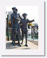 Statue on the waterfront of Annie Moore and her brothers. Annie Moore was the first person to be admitted to the United States of America through the new immigration centre at Ellis Island, New York on 1 January 1892