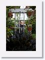 An interesting use of an old door with a mirror replacing the glass and pot hangers along the edges